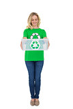 Smiling cute environmental activist holding recycling box