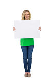 Cheerful cute blonde holding white sign