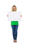 Smiling cute blonde holding white poster