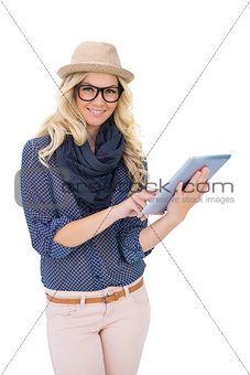 Happy trendy blonde holding tablet computer