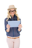 Happy trendy blonde holding tablet pc