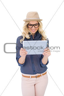 Happy trendy blonde looking at tablet pc
