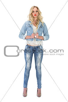 Serious casual blonde wearing denim clothes posing