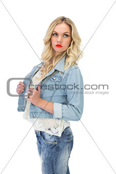 Pensive casual blonde wearing denim clothes posing