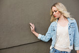 Gorgeous casual blonde wearing denim clothes posing outdoors