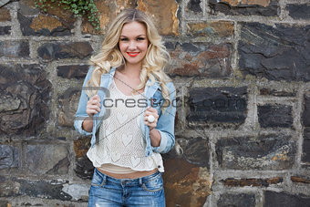 Happy casual blonde wearing denim clothes posing outdoors