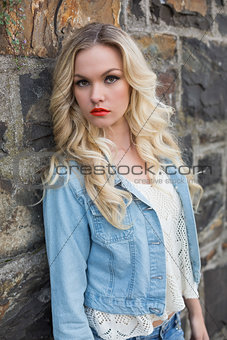 Pretty blonde wearing denim clothes posing outdoors