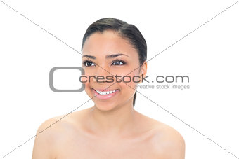 Smiling young dark haired model looking away