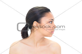 Profile view of a serious dark haired model posing