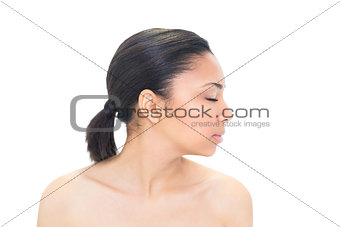 Profile view of a thoughtful dark haired model closing her eyes