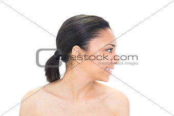 Profile view of a content dark haired model posing
