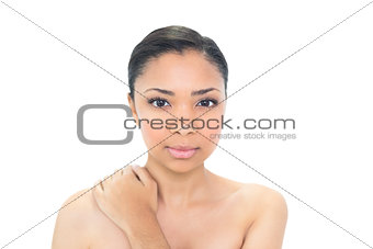 Stern young black haired model looking at camera