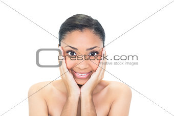 Amused young dark haired model holding her head