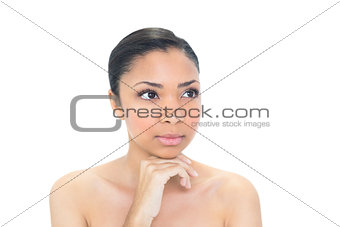 Unsmiling young dark haired model looking away