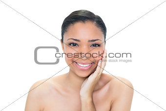 Joyful young dark haired model touching her cheek