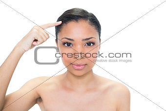 Attractive young dark haired model pointing her hair with her finger