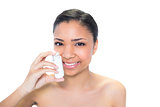 Cheerful young dark haired model using athma inhaler