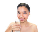 Cheerful young dark haired model holding a glass of water