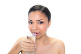 Lovely young dark haired model drinking water