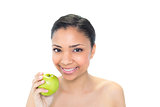 Beautiful young dark haired model holding a green apple