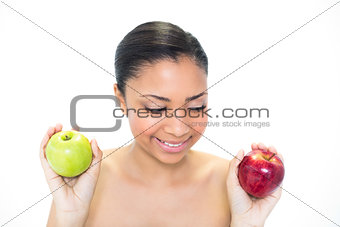 Seductive young dark haired model holding apples