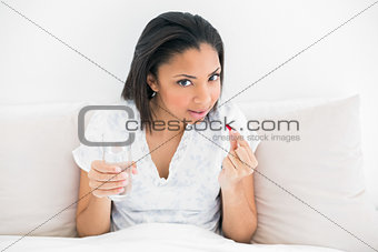 Pretty young dark haired model taking medication