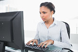 Concentrated young dark haired businesswoman using a computer