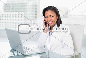 Stylish young dark haired businesswoman making a phone call