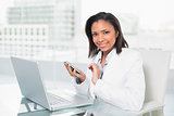 Natural young dark haired businesswoman using a mobile phone