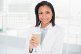 Lovely young dark haired businesswoman holding a cup of coffee