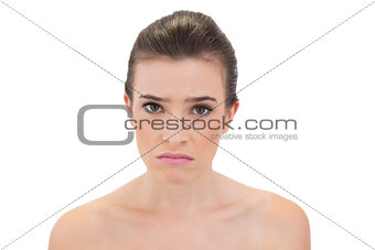 Troubled natural brown haired model looking at camera