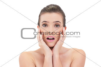 Disappointed natural brown haired model touching her face