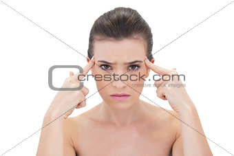 Troubled natural brown haired model touching her temples