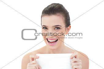 Delighted natural brown haired model holding a tissue
