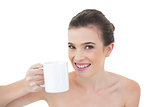 Joyful natural brown haired model holding a mug of coffee