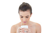 Relaxed natural brown haired model holding a mug of coffee