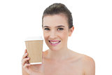 Pleased natural brown haired model holding a cup of coffee