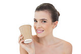 Amused natural brown haired model holding a cup of coffee