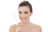 Gorgeous natural brown haired model holding a nail file