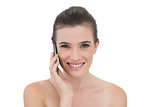 Delighted natural brown haired model making a phone call