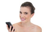 Gorgeous natural brown haired model holding a mobile phone