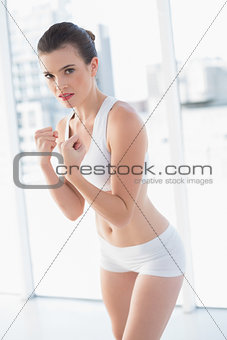 Dynamic fit brown haired model in sportswear preparing to fight
