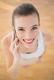 Gorgeous fit brown haired model in sportswear making a phone call