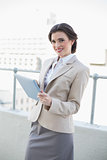 Beautiful stylish brown haired businesswoman using a tablet pc