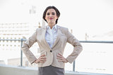 Gorgeous stylish brown haired businesswoman standing with hands on the hips