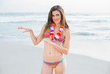 Smiling slim brown haired model in coloured bikini dancing