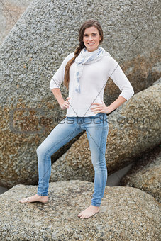 Confident young brown haired model posing with hands on the hips