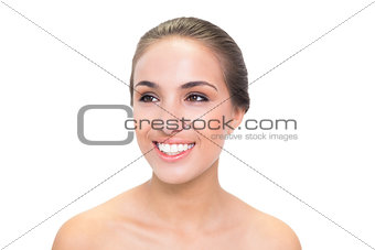 Smiling young brunette woman looking away