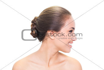 Smiling young brunette woman looking right