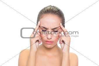 Upset young brunette woman closing her eyes